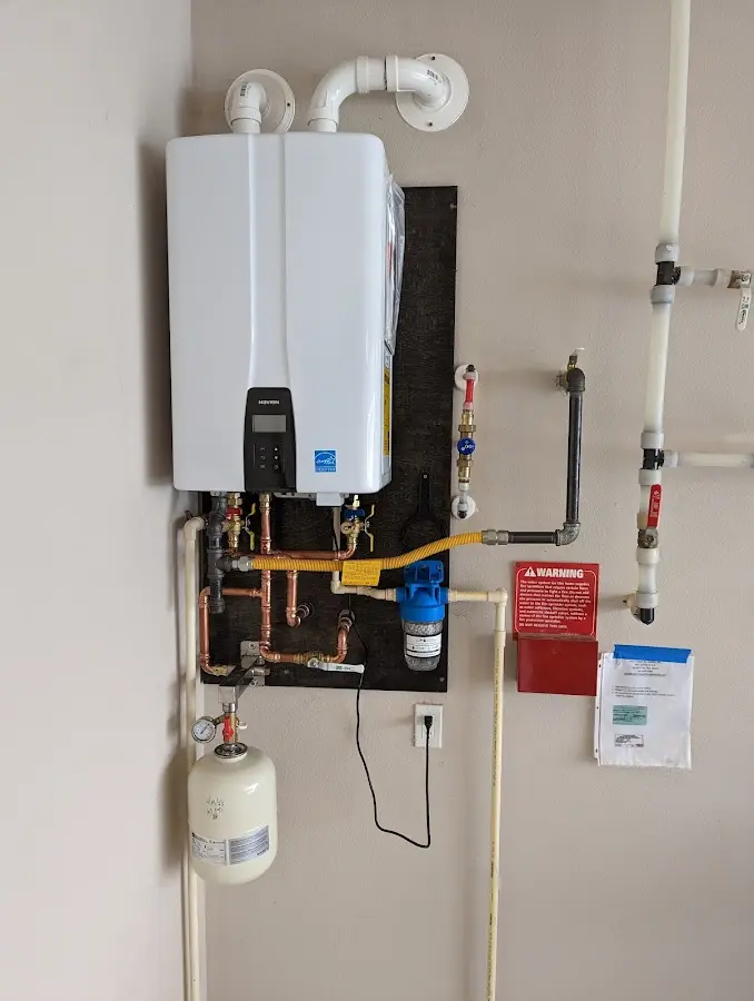 Professional plumber installing copper piping in a Rifle home